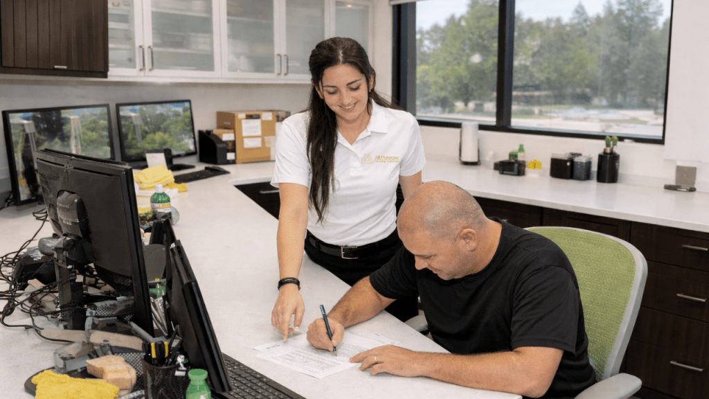 APCS team member onboarding a new employee in an office setting at All Purpose Cleaning Solutions